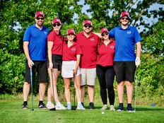 Six golfers standing together