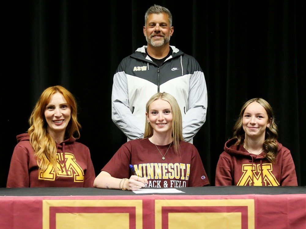 Skarlit Worton, centre, is joined by her mother Jessica, sister Cylver and coach Joel Skinner for her signing ceremony with the University of Minnesota track and field team. Mark Malone