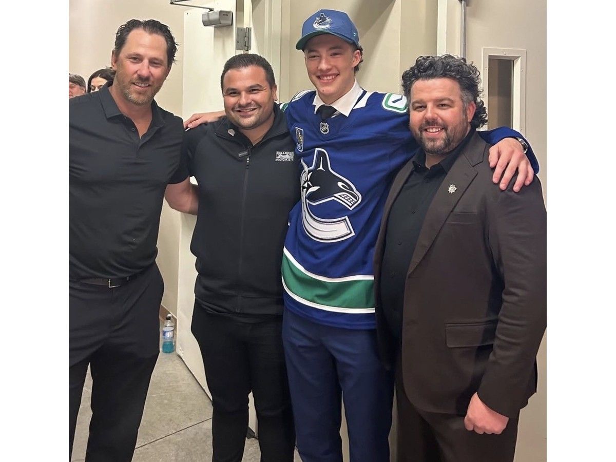Brantford Bulldogs centre Caleb Malhotra - with (left to right) former coach Jay McKee, general manager Spencer Hyman and assistant general manager Justin Ismael - was selected third overall by the Vancouver Canucks on Friday night during the NHL Entry Draft.