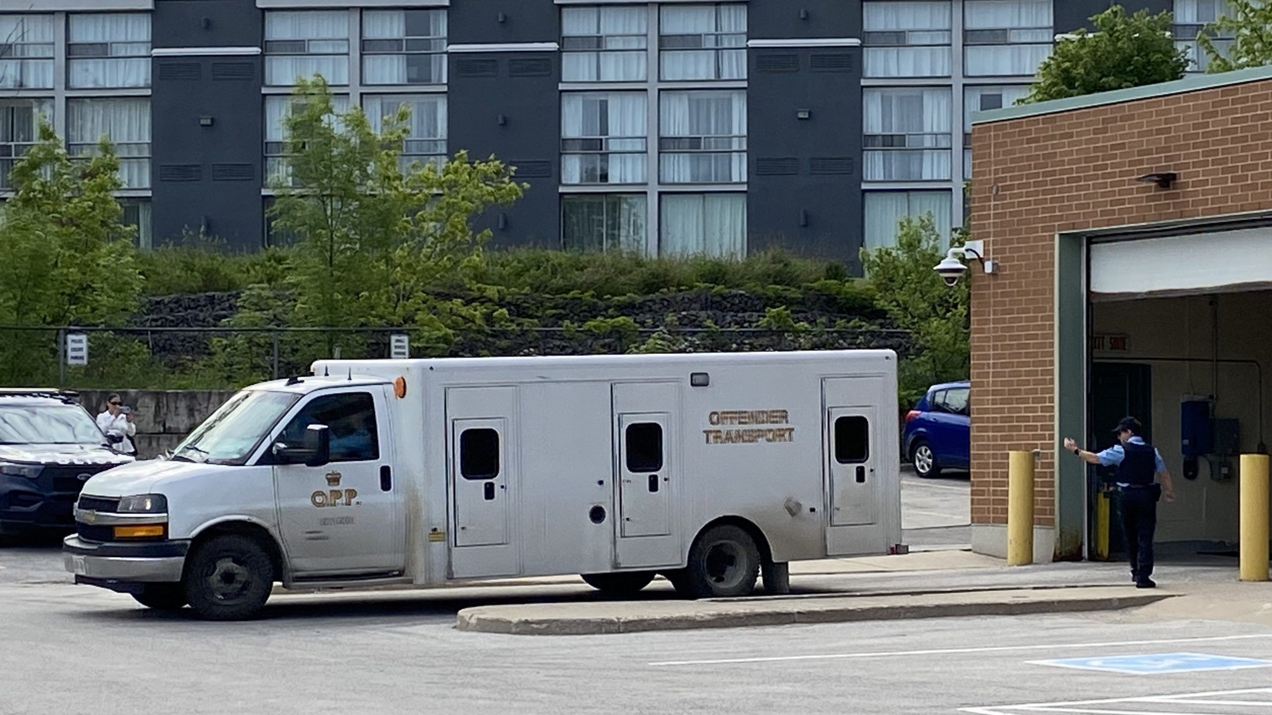 A prisoner van containing men charged in the death of Sharif Rahman backs in to the sally port at the Owen Sound Courthouse on Friday, June 5, 2026.