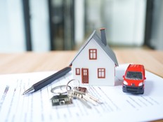 Stock photo of home, keys, on top of a lease agreement