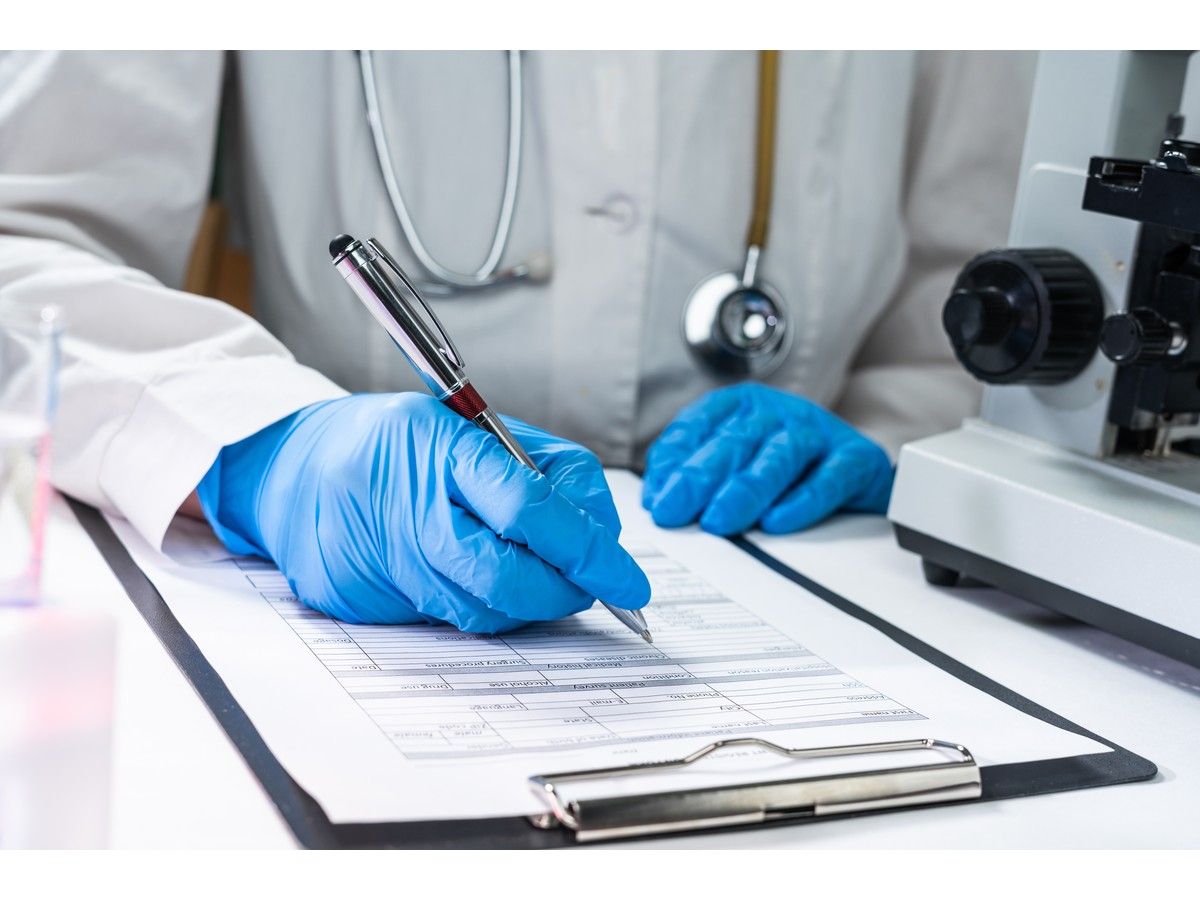 Fiule photo of physician writing on a chart