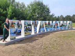 Artist Heather Desormeaux poses with Petawawa's new letter sign