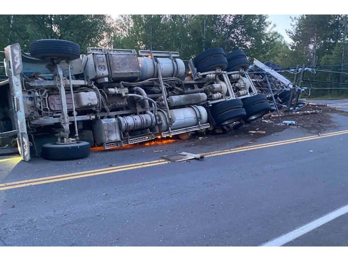 Logging truck flips in Minto, appears to damage stone bridge