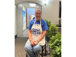 woman in apron sitting on chair