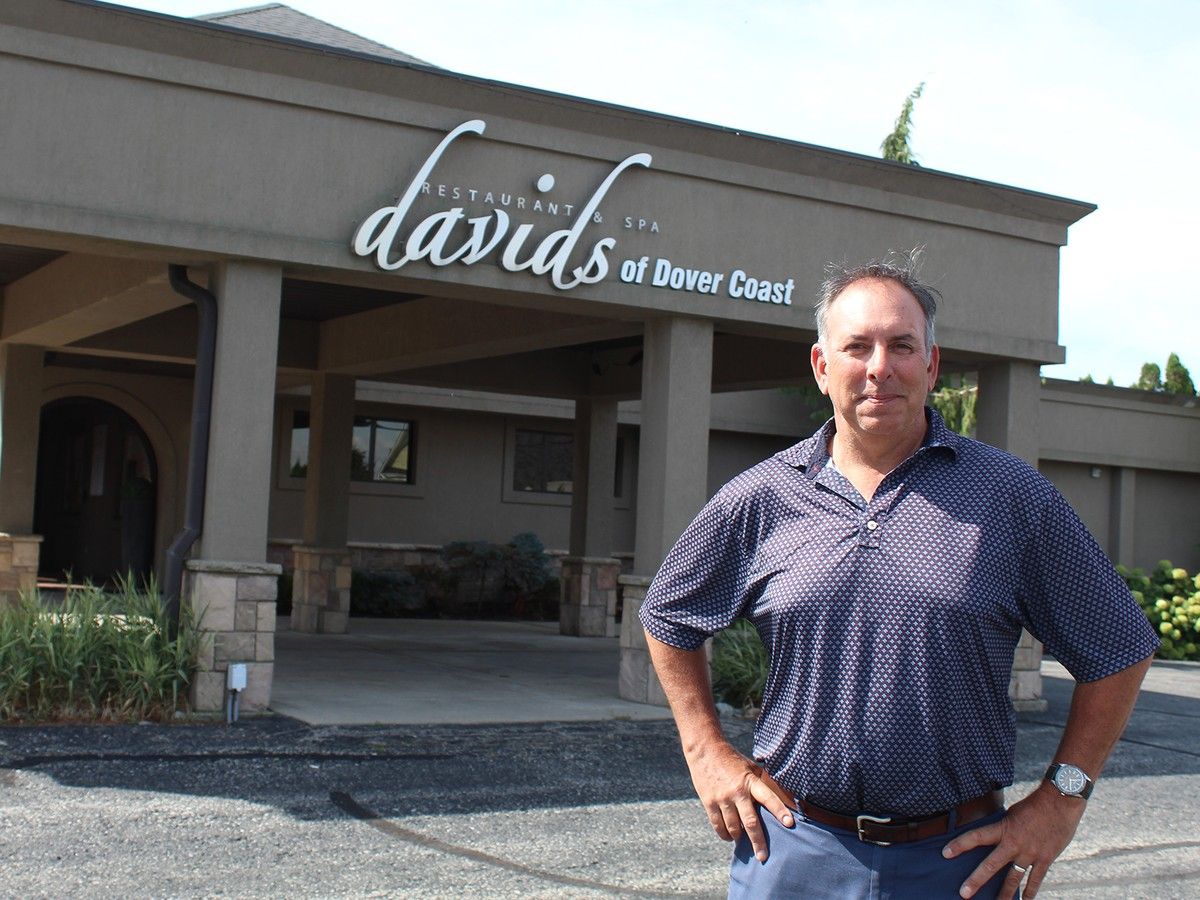 Man standing outside restaurant