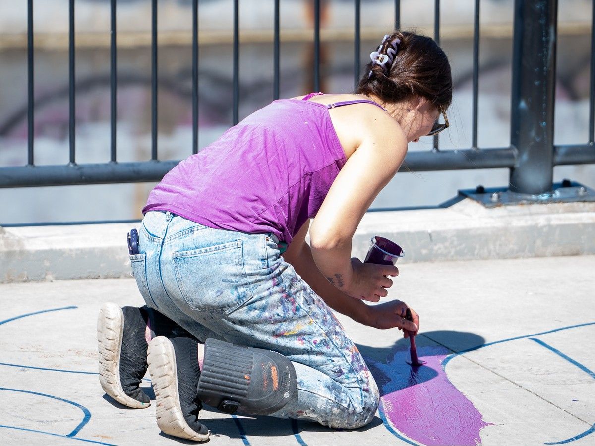 Artist Elsie Yanick paints a mural. Fort McMurray, Alta. August 20, 2026. Photo provided by RMWB.