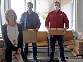 Nipissing Detoxification and Substance Abuse Program secretary Darlene Hoffman, left, and North Bay Regional Health Centre (NBRHC) King Street campus interim manager Sandy Deschenes, right, accept a lunch delivery Friday from Michael Costakos, second from left, and Paul Ricci.
Michael Lee/The Nugget