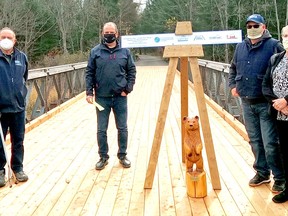 John Miller, left, of the Near North Trails Association -- Ontario Federation of Snowmobile Clubs District 11, North Bay Mattawa Conservation Authority chair Dave Mendicino, vice-chair Dave Britton, and South Shore Restoule Snowmobile Club president Diane Tregunna officially open the La Vase River Bridge on Kate Pace Way, Thursday. Supplied photo