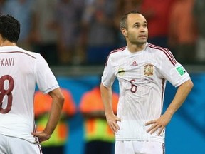 Fernando Torres of Spain (L) and Andres Iniesta (R)  look dejected during their lopsided loss to the Netherlands at Arena Fonte Nova on June 13, 2014 in Salvador, Brazil.  (Photo by Quinn Rooney/Getty Images)