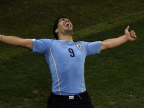 Uruguay's forward Luis Suarez celebrates after scoring during a Group D football match between Uruguay and England at the Corinthians Arena in Sao Paulo during the 2014 FIFA World Cup on June 19, 2014.