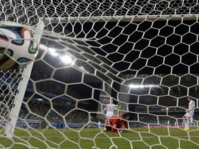 TOPSHOTS  Bosnia-Hercegovina's goalkeeper Asmir Begovic (C) concedes a goal to Nigeria's forward Peter Odemwingie during the Group F football match between Nigeria and Bosnia-Hercegovina at the Pantanal Arena in Cuiaba during the 2014 FIFA World Cup on June 21, 2014.  AFP PHOTO / JUAN BARRETOJUAN BARRETO/AFP/Getty Images