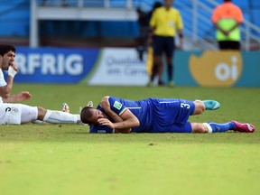 Luis Suarez checks his teeth after taking a chomp out of Giorgio Chiellini’s shoulder during Uruguay’s 1-0 win over Italy on Tuesday. It’s the third time the forward has bitten an opponent during a game.