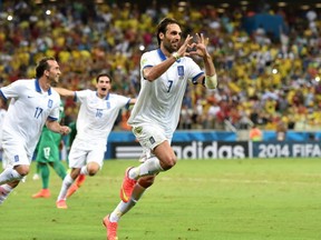 Greece's forward Georgios Samaras (C) celebrates scoring a penalty during a Group C football match between Greece and Ivory Coast at the Castelao Stadium in Fortaleza during the 2014 FIFA World Cup on June 24, 2014. AFP PHOTO / ARIS MESSINISARIS MESSINIS/AFP/Getty Images