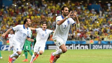 Greece's forward Georgios Samaras (C) celebrates scoring a penalty during a Group C football match between Greece and Ivory Coast at the Castelao Stadium in Fortaleza during the 2014 FIFA World Cup on June 24, 2014. AFP PHOTO / ARIS MESSINISARIS MESSINIS/AFP/Getty Images