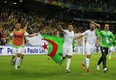 Algeria's midfielder Saphir Taider (C), Algeria's forward Nabil Ghilas (2nd R) and Algeria's defender Madjid Bougherra (front L) celebrate at the end of their Group H football match against Russia at the Baixada Arena in Curitiba during the 2014 FIFA World Cup on June 26, 2014.     AFP PHOTO / ADRIAN DENNISADRIAN DENNIS/AFP/Getty Images