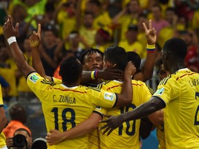 Colombia's midfielder James Rodriguez (C) celebrates scoring the 2-0 goal with his teammates during the Round of 16 football match between Colombia and Uruguay at the Maracana Stadium in Rio de Janeiro during the 2014 FIFA World Cup in Brazil on June 28, 2014. (LUIS ACOSTA/AFP/Getty Images)