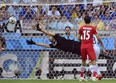 Iran's goalkeeper Alireza Haghighi dives but fails to stop a goal by Argentina's Lionel Messi during the group F World Cup soccer match between Argentina and Iran at the Mineirao Stadium in Belo Horizonte, Brazil, Saturday, June 21, 2014. Argentina defeated Iran 1-0. (AP Photo/Martin Meissner)