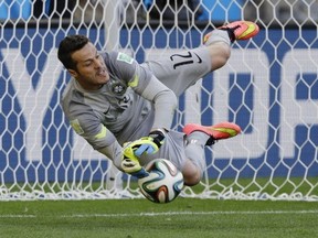 Brazil's goalkeeper Julio Cesar makes a save during a penalty shootout following regulation time during the World Cup round of 16 soccer match between Brazil and Chile at the Mineirao Stadium in Belo Horizonte, Brazil, Saturday, June 28, 2014. Brazil won 3-2 on penalties after a 1-1 tie. (AP Photo/Ricardo Mazalan)
