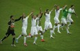 Members of the Algerian soccer team join hands as they celebrate on the pitch after winning 4-2 , the group H World Cup soccer match between South Korea and Algeria at the Estadio Beira-Rio in Porto Alegre, Brazil, Sunday, June 22, 2014. (AP Photo/Michael Sohn)