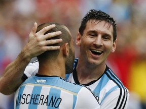 Argentina's Lionel Messi, right, hugs his teammate Javier Mascherano after scoring his side's second goal during the group F World Cup soccer match against Nigeria at the Estadio Beira-Rio in Porto Alegre, Brazil, Wednesday, June 25, 2014.  (AP Photo/Jon Super)
