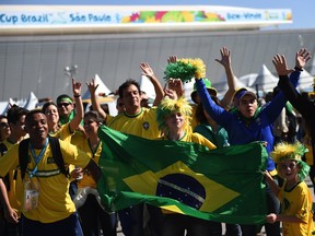 Brazilian fans wave outside the Corinthians Arena in Sao Paulo prior to the start of the Group A opening football match between Brazil and Croatia during the 2014 FIFA World Cup on June 12, 2014. AFP PHOTO / PEDRO UGARTEPEDRO UGARTE