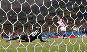 Croatia's Mario Mandzukic, right, scores his side's fourth goal past Cameroon's goalkeeper Charles Itandje, left.  
(Associated Press  Photo/Marcio Jose Sanchez)