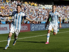 Argentina's Lionel Messi, left, celebrates after scoring during the group F World Cup soccer match between Argentina and Iran at the Mineirao Stadium in Belo Horizonte, Brazil, Saturday, June 21, 2014. (AP Photo/Jon Super)