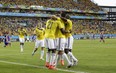 Colombia's players celebrate after scoring their second goal during the group C World Cup soccer match between Japan and Colombia at the Arena Pantanal in Cuiaba, Brazil, Tuesday, June 24, 2014. (AP Photo/Felipe Dana)
