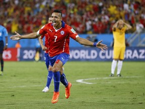 Chile's Alexis Sanchez (7) celebrates after scoring his side's first goal  (Associated Press/Kirsty Wigglesworth)