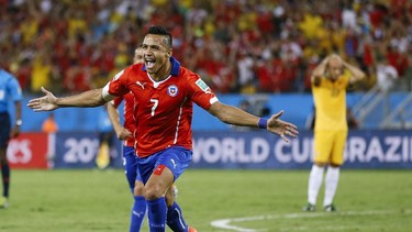 Chile's Alexis Sanchez (7) celebrates after scoring his side's first goal  (Associated Press/Kirsty Wigglesworth)