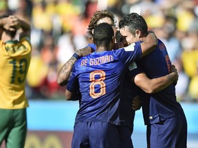Dutch players celebrate after Netherlands' Memphis Depay scored his side's third goal during the group B World Cup soccer match between Australia and the Netherlands at the Estadio Beira-Rio in Porto Alegre, Brazil, Wednesday, June 18, 2014.   (AP Photo/Martin Meissner)
