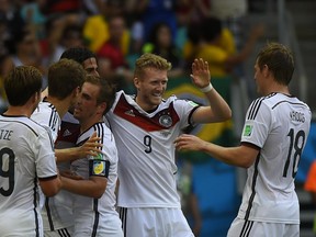 Germany's players including goalscorer forward Thomas Muller (2L) and forward Andre Schuerrle (C) celebrate his goal during the Group G match between Germany and Portugal at the Fonte Nova Arena in Salvador on June 16, 2014, during the 2014 FIFA World Cup.