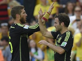 Spain's forward Juan Mata (R) and Spain's defender Sergio Ramos celebrate after Spain's forward Fernando Torres scored his team's second goal during a Group B match between Australia and Spain at the Baixada Arena in Curitiba during the 2014 FIFA World Cup on June 23, 2014.  LUIS GENE/AFP/Getty Images