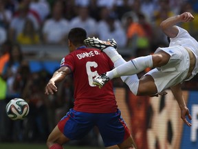 Costa Rica's defender Oscar Duarte (L) tackles England's defender Gary Cahill during the Group D football match between Costa Rica and England at The Mineirao Stadium in Belo Horizonte on June 24, 2014,during the 2014 FIFA World Cup . AFP PHOTO / FABRICE COFFRINIFABRICE COFFRINI/AFP/Getty Images