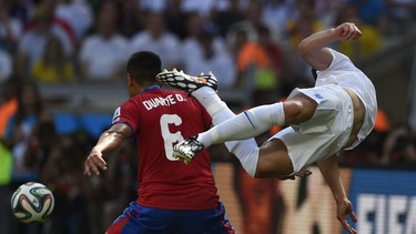 Costa Rica's defender Oscar Duarte (L) tackles England's defender Gary Cahill during the Group D football match between Costa Rica and England at The Mineirao Stadium in Belo Horizonte on June 24, 2014,during the 2014 FIFA World Cup . AFP PHOTO / FABRICE COFFRINIFABRICE COFFRINI/AFP/Getty Images