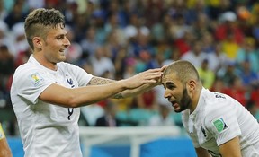 France's Olivier Giroud, left, touches the head of Karim Benzema during the group E World Cup soccer match between Switzerland and France at the Arena Fonte Nova in Salvador, Brazil, Friday, June 20, 2014.  (AP Photo/David Vincent)