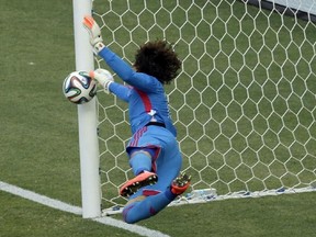 Mexico's goalkeeper Guillermo Ochoa makes a save during the group A World Cup soccer match between Brazil and Mexico at the Arena Castelao in Fortaleza, Brazil, Tuesday, June 17, 2014.  (AP Photo/Themba Hadebe)