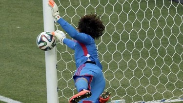 Mexico's goalkeeper Guillermo Ochoa makes a save during the group A World Cup soccer match between Brazil and Mexico at the Arena Castelao in Fortaleza, Brazil, Tuesday, June 17, 2014.  (AP Photo/Themba Hadebe)