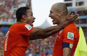 Netherlands' Memphis Depay, left, celebrates with teammate Arjen Robben after scoring his side's second goal during the group B World Cup soccer match between the Netherlands and Chile at the Itaquerao Stadium in Sao Paulo, Brazil, Monday, June 23, 2014. (AP Photo/Frank Augstein)
