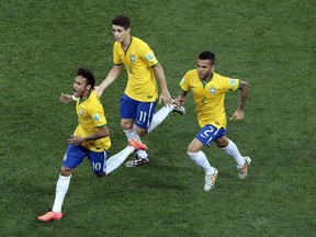 Brazil's Neymar, left, celebrates scoring his side's first goal during the group A World Cup soccer match between Brazil and Croatia, the opening game of the tournament, in the Itaquerao Stadium in Sao Paulo, Brazil, Thursday, June 12, 2014.  (AP Photo/Shuji Kajiyama)