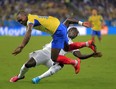 Ecuador's Walter Ayovi collides with France's Bacary Sagna during the group E World Cup soccer match between Ecuador and France at the Maracana Stadium in Rio de Janeiro, Brazil, Wednesday, June 25, 2014. (AP Photo/Bernat Armangue)