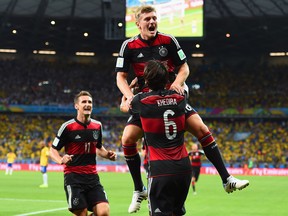 Toni Kroos of Germany celebrates scoring his team's fourth goal with teammates Miroslav Klose, left, and Sami Khedira during the World Cup Brazil semifinal match between Brazil and Germany at Estadio Mineirao on July 8, 2014 in Belo Horizonte, Brazil.  (Photo by Buda Mendes/Getty Images)
