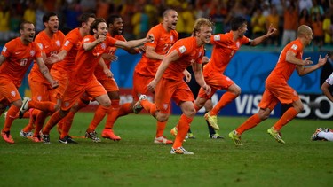 Netherlands players celebrate after the quarter-final football match between the Netherlands and Costa Rica at the Fonte Nova Arena in Salvador during the 2014 FIFA World Cup on July 5, 2014.  AFP PHOTO / ODD ANDERSENODD ANDERSEN/AFP/Getty Images