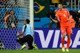 Netherlands' forward and captain Robin van Persie (R) celebrates after scoring past Costa Rica's goalkeeper Keylor Navas during the penalty shootout. RONALDO SCHEMIDT/AFP/Getty Images