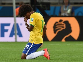 Brazil's midfielder Willian reacts at the end of the semifinal football match between Brazil and Germany at The Mineirao stadium in Belo Horizonte during the 2014 FIFA World Cup on July 8, 2014. Germany won 7-1.  
AFP PHOTO / VANDERLEI ALMEIDA/AFP/Getty Images