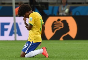 Brazil's midfielder Willian reacts at the end of the semifinal football match between Brazil and Germany at The Mineirao stadium in Belo Horizonte during the 2014 FIFA World Cup on July 8, 2014. Germany won 7-1.  
AFP PHOTO / VANDERLEI ALMEIDA/AFP/Getty Images