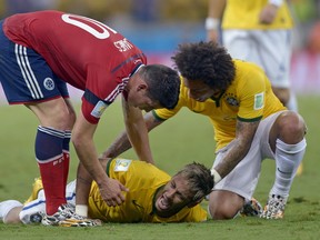 Brazil's Neymar screams in pain after being fouled during the World Cup quarter-final match against Colombia at the Arena Castelao in Fortaleza, Brazil, Friday, July 4, 2014. Neymar will miss the rest of the World Cup after breaking a vertebrae during Brazil's win over Colombia.