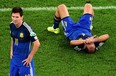 Argentina's Pablo Zabaleta lies on the pitch as Lionel Messi stands beside him after their 1-0 loss to 
Germany in the World Cup final at the Maracana Stadium in Rio de Janeiro, Brazil, on Sunday.