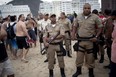 Police stand guard as Argentina soccer fans gather on Copacabana beach during the World Cup in Rio de Janeiro, Brazil, Friday, July 11, 2014. Argentina will face Germany at the final World Cup match on Sunday. (AP Photo/Rodrigo Abd)